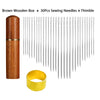 Brown wooden box containing a set of 30 sewing needles and a thimble
