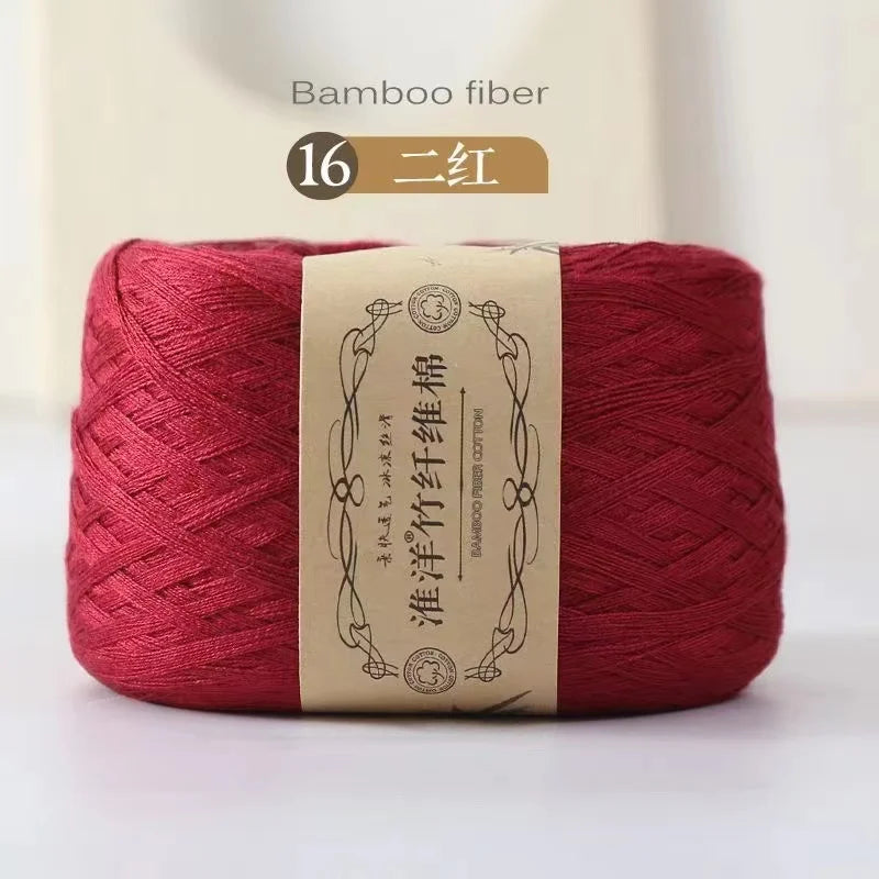 A skein of deep red bamboo fiber yarn labeled as 16 strands for knitting and crochet.