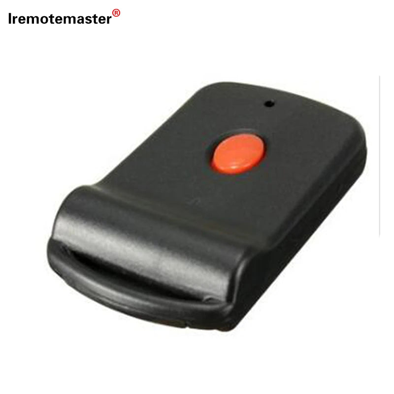 Black garage door remote control with an orange button and a dip switch for programming