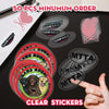 A hand holds a sheet of clear stickers and several round die-cut vinyl stickers featuring various logos like Clear Smiles and