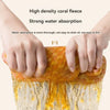 Hands are squeezing a high density coral fleece cleaning cloth that demonstrates strong water absorption.