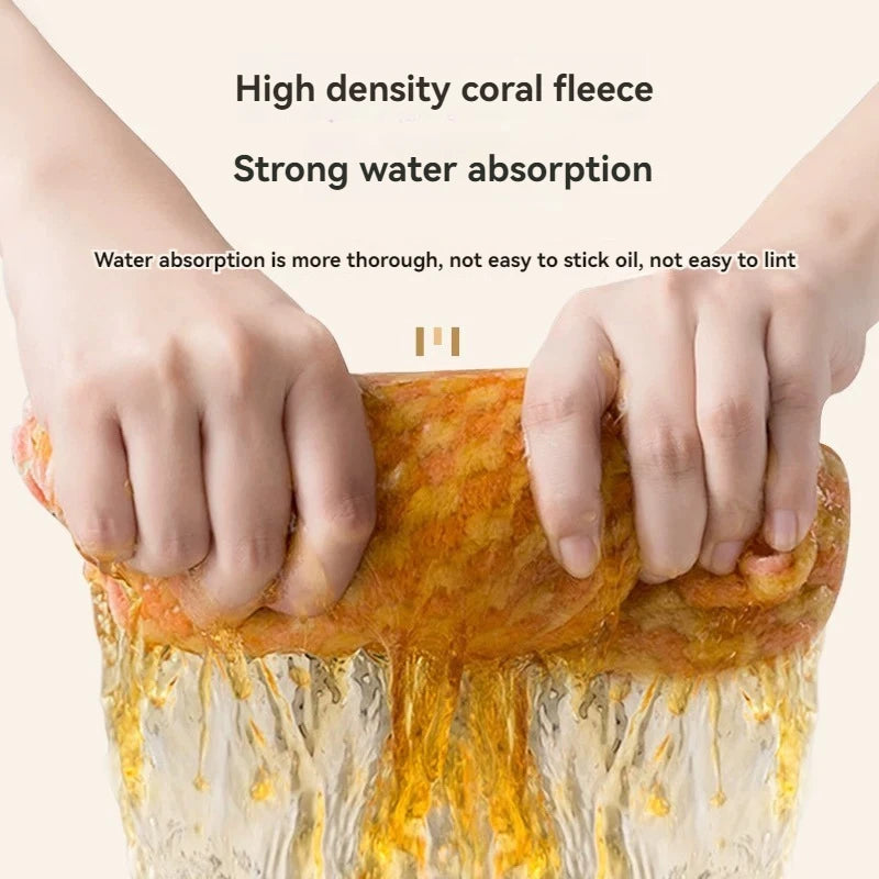 Hands are squeezing a high density coral fleece cleaning cloth that demonstrates strong water absorption.