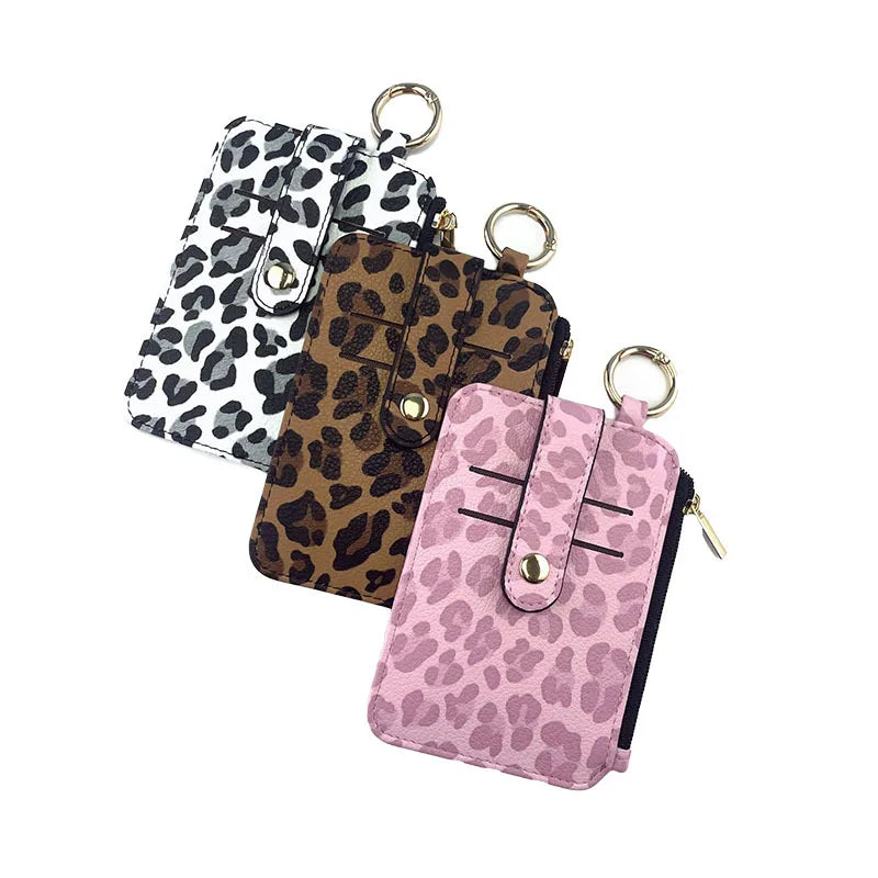 A collection of leopard print PU leather card holders in various patterns, including black and white, brown, and pink.