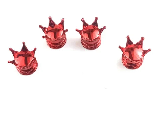 A set of four shiny red universal crown valve caps arranged horizontally on a white background.