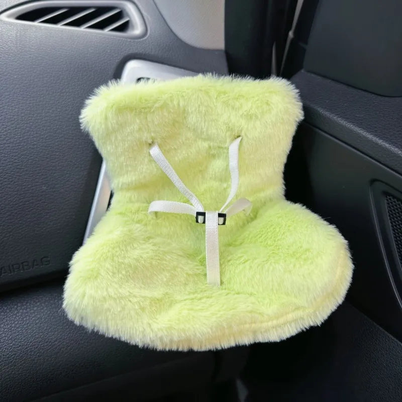 A fluffy lime green miniature doll seat car vent decoration with a white tie.