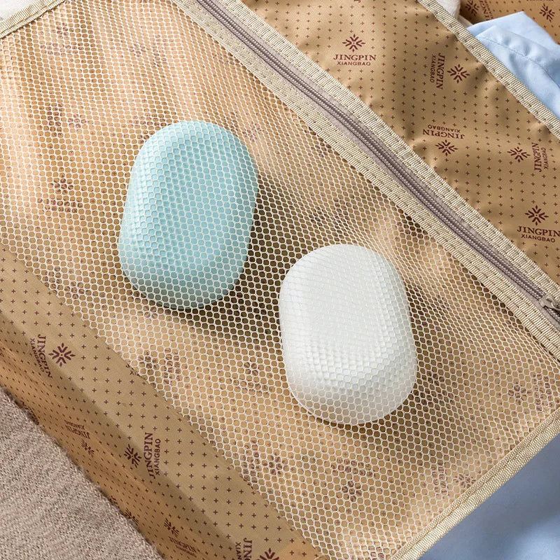 A light blue and white portable soap dish with a lid is displayed inside a woven brown fabric bag.