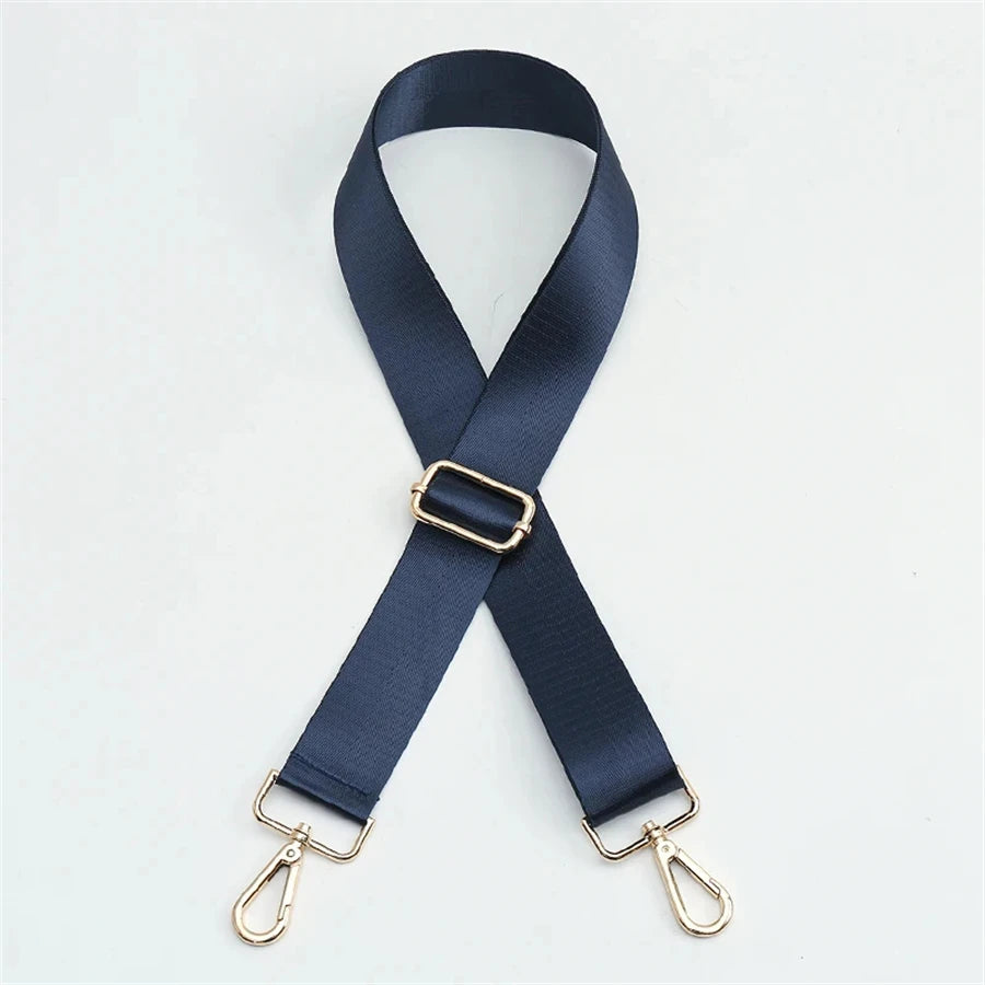 A dark navy nylon bag strap with a gold buckle and metal clasps.