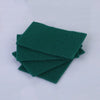 A stack of dark green microfiber kitchen scrub sponges for dishes and countertops.