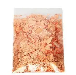 A close-up view of metallic foil flakes used for crafting, nail art, and resin projects.