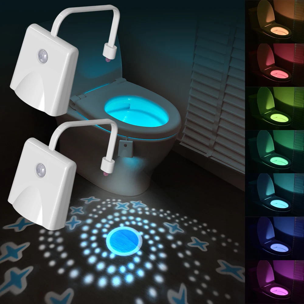 A white rechargeable motion sensor toilet night light with a glowing blue light and multiple color modes is shown on a toilet