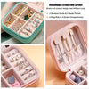 Pink PU leather jewelry storage box with divided compartments for rings and necklaces