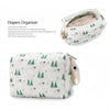 A white diaper organizer bag with a subtle green and gray pattern, featuring a zippered opening.