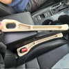 A beige car seat gap filler and storage organizer is shown in the interior of a vehicle.
