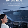 A woman is driving a car, and the Baseus CoolRide windshield sun shade umbrella cluster is visible inside the vehicle.