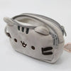 A soft gray cat plush pencil case with a zipper closure is shown from the front.