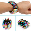 A set of iridescent magnetic fidget balls displayed on a wrist and separate from the storage case.