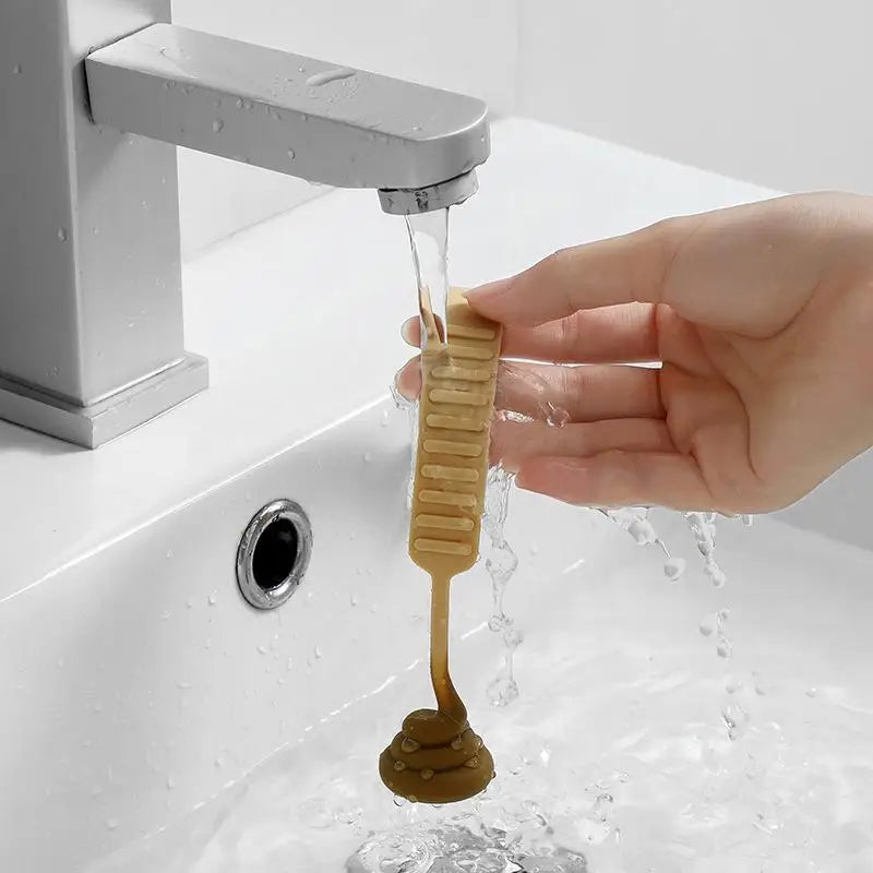 A hand is using a hands-free toilet lid lifter to lift the lid of a toilet bowl.