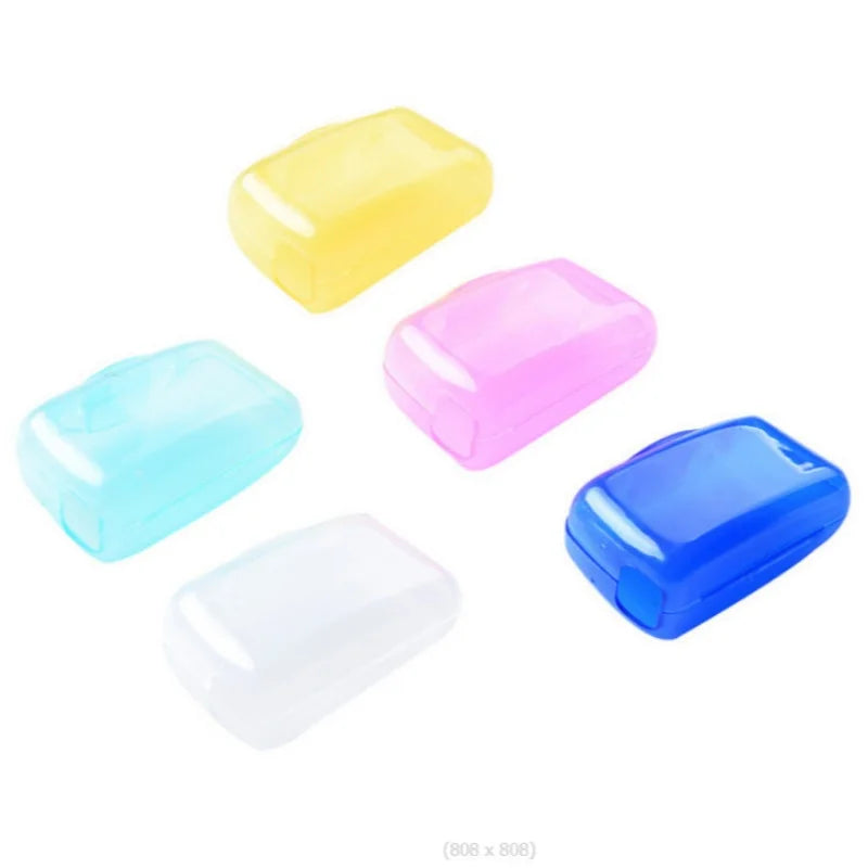 A set of four colorful protective toothbrush head covers with travel clips in yellow, pink, light blue, and blue.