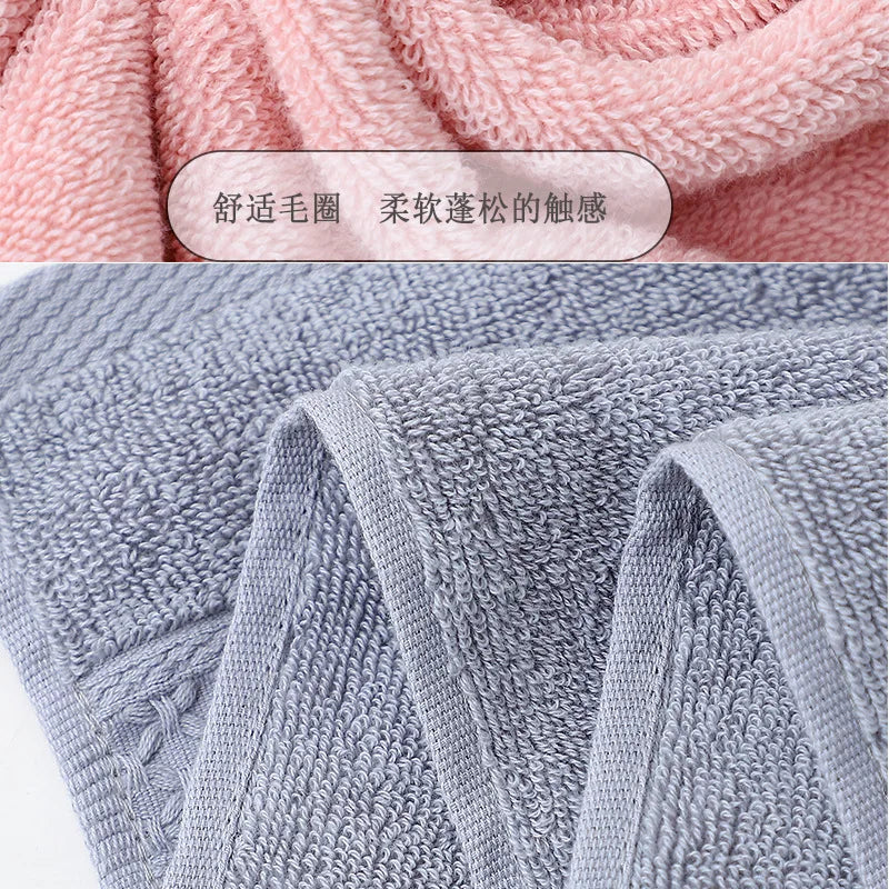 Close-up view of a set of soft, textured face towels in light pink and gray colors