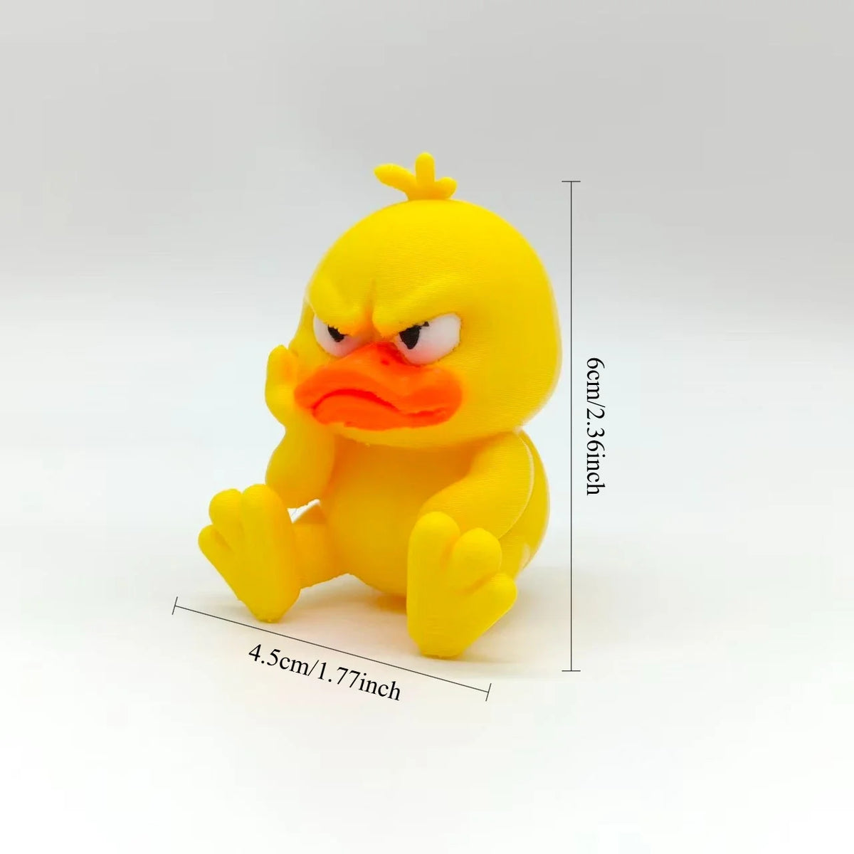 A yellow, angry-looking duck statue decoration with orange facial features and yellow body.