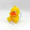 A yellow, angry-looking duck statue decoration with orange facial features and yellow body.