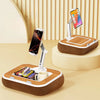 A wooden phone stand and lap desk with a rotating phone holder and a smartphone on top.