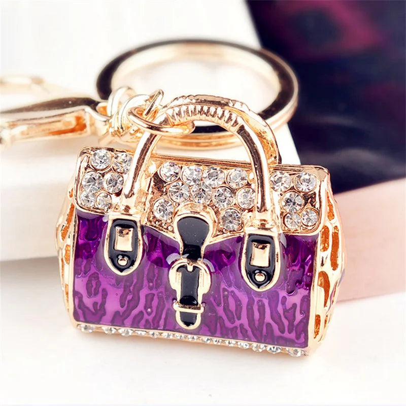 Gold-toned crystal rhinestone handbag keychain with a purple leopard print detail