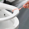 A hand is using a silicone toilet seat lifter with a pull ring to lift the seat on a white toilet.