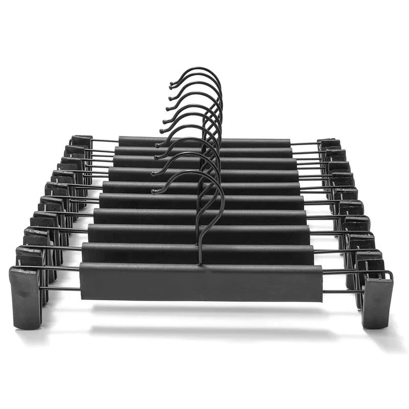 Black space-saving adjustable clip hangers for pants, skirts, and trousers.
