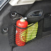 A red bottle is stored in an elastic mesh pocket within a black car seat back organizer.