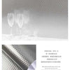 Brushed silver peel-and-stick metal wallpaper featuring a subtle geometric pattern on a surface.