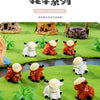 A collection of colorful resin highland cow figurines in various poses displayed on a green landscape background.