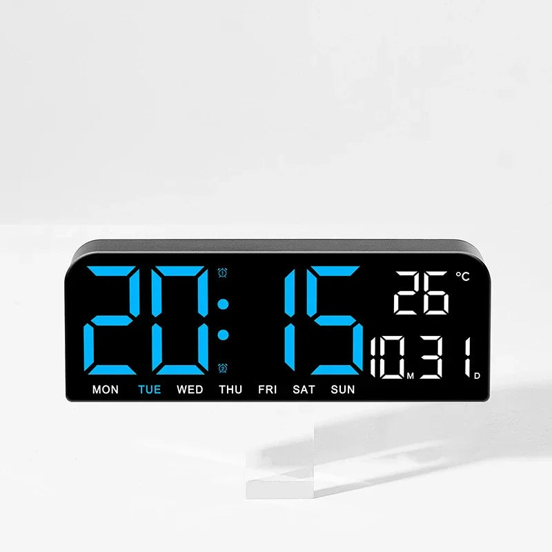 A black digital wall clock displaying 20:15 and a temperature of 26 degrees Celsius.