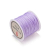 A spool of purple 0.8mm nylon macramé cord for jewelry making.