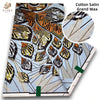 Cotton Satin Grand Wax fabric featuring a patterned print with gold and black designs.