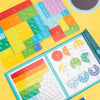 A colorful magnetic wooden fraction learning book with various fraction cards and a half circle shown on a yellow background.