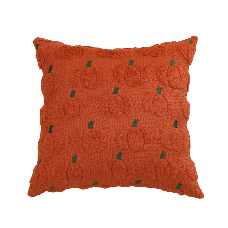 An orange pumpkin patterned plush throw pillow cover with green accents.