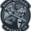 A dark gray patch featuring the archangel St. Michael with wings and a sword, surrounded by text that reads Saint Michael Pro
