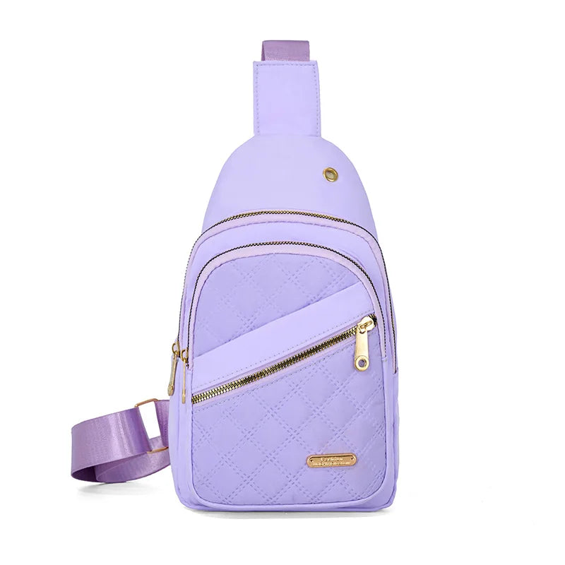 A light purple quilted crossbody sling bag with a zipper and strap.