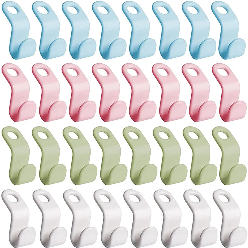 A collection of light blue and pink plastic hanger connector hooks for space-saving wardrobe organization
