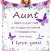 A purple floral fleece blanket featuring a butterfly design and the text I hope every time you snuggle this blanket it remind