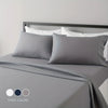 A gray microfiber bed sheet set with white pillows and a matching gray duvet on a bed.