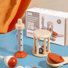 A set of five wooden musical instruments including a rattle, bell, and various wooden toys for babies.