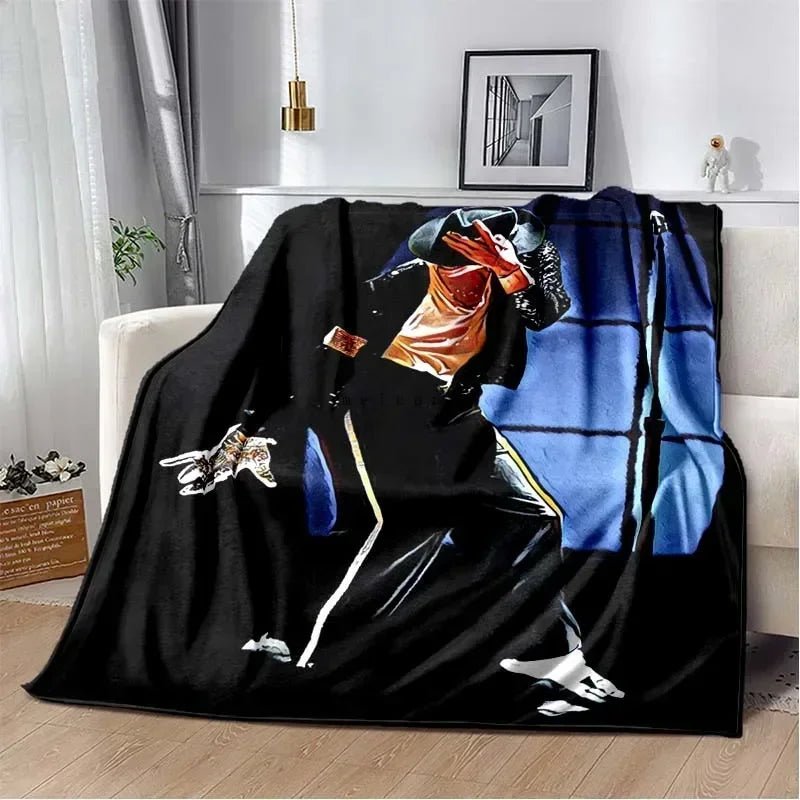 A black flannel throw blanket featuring a print of Michael Jackson in a dynamic pose.