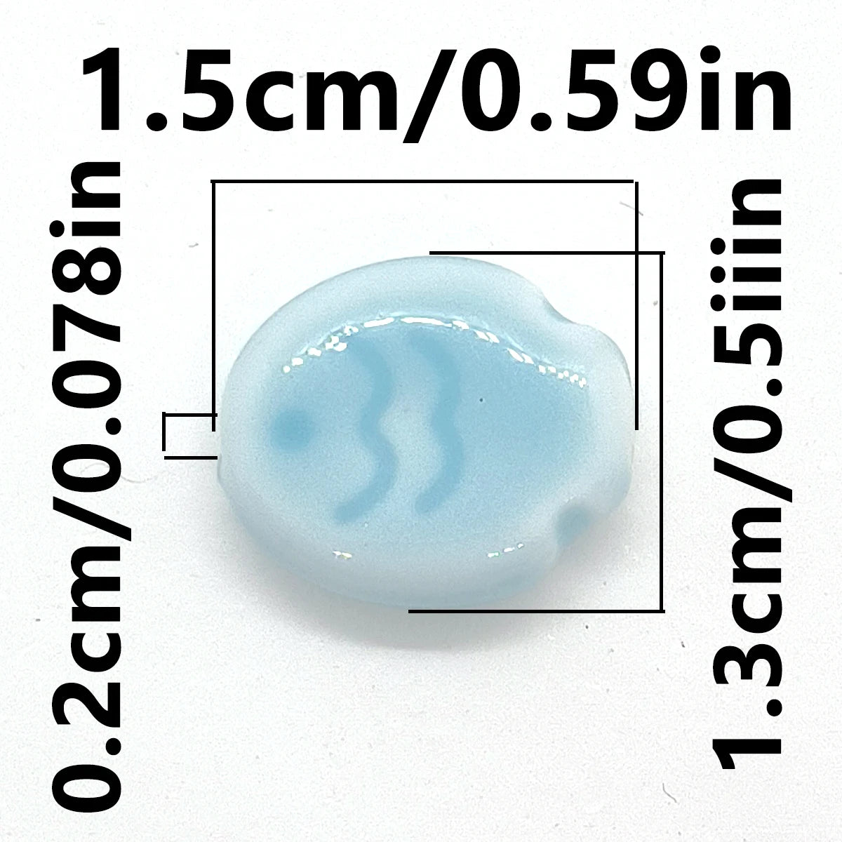 A light blue, oval-shaped ceramic fish bead is shown with dimension lines indicating its size.