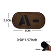 A rectangular brown glow-in-the-dark tactical patch with a hook and loop backing shown next to a loop and hook.