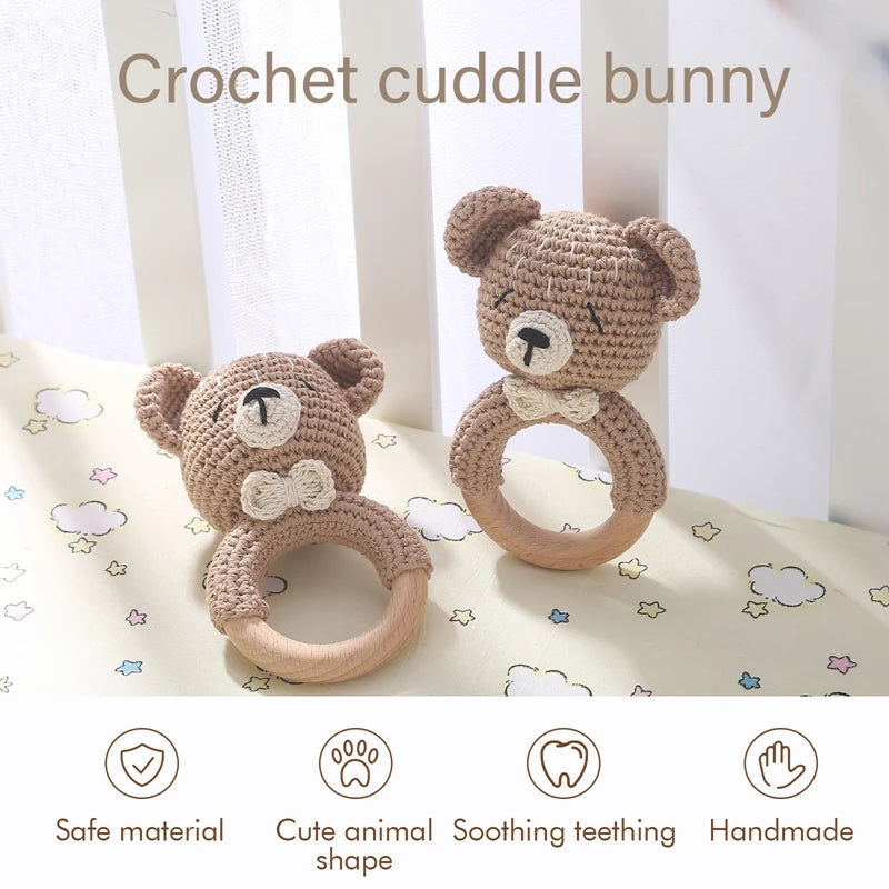 A handmade crochet bunny toy with a natural wood teether ring shown against a light background.