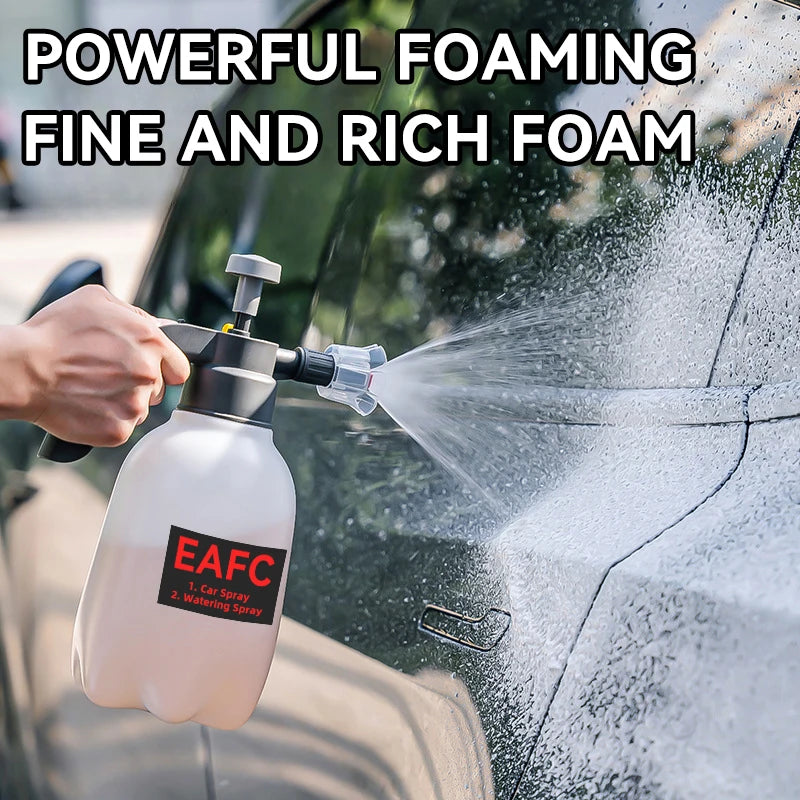 A hand is using a white foam sprayer to apply fine, rich foam onto the surface of a car.