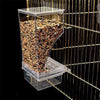 Clear acrylic no-mess bird feeder and waterer with seeds inside, positioned against a gold wire background.