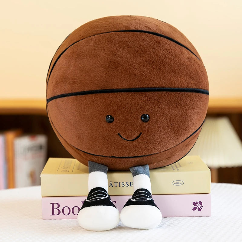A brown plush toy resembling a sports ball sits on a stack of books.